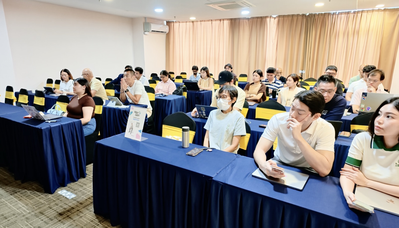 Participants attending the practical HeyGen demonstration